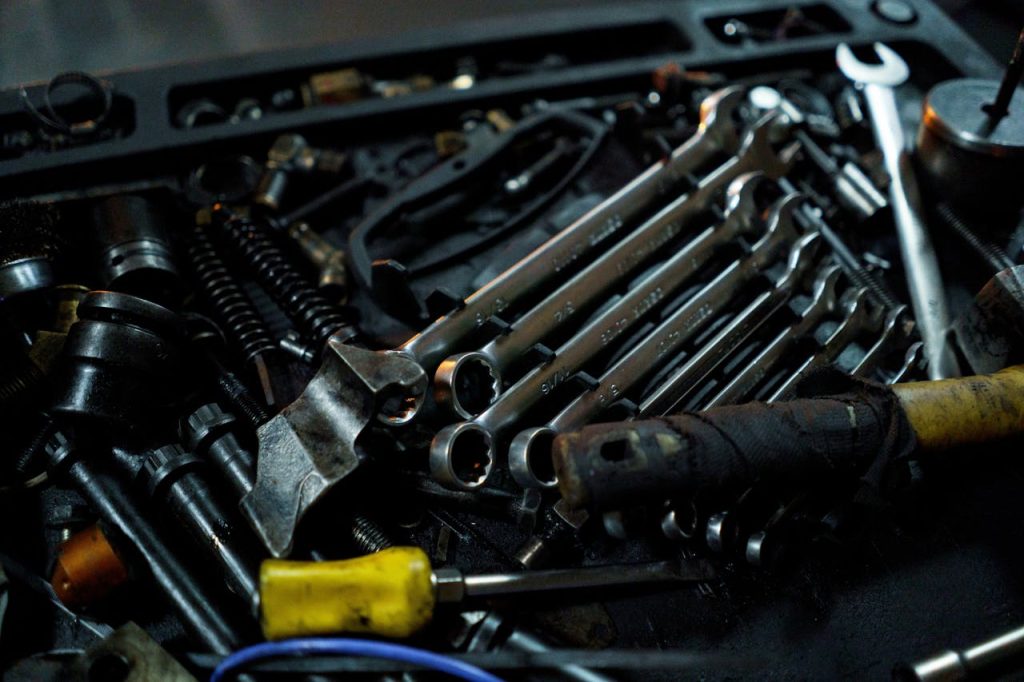 Detailed view of various mechanical tools laid out in a toolbox, ideal for industrial themes.
